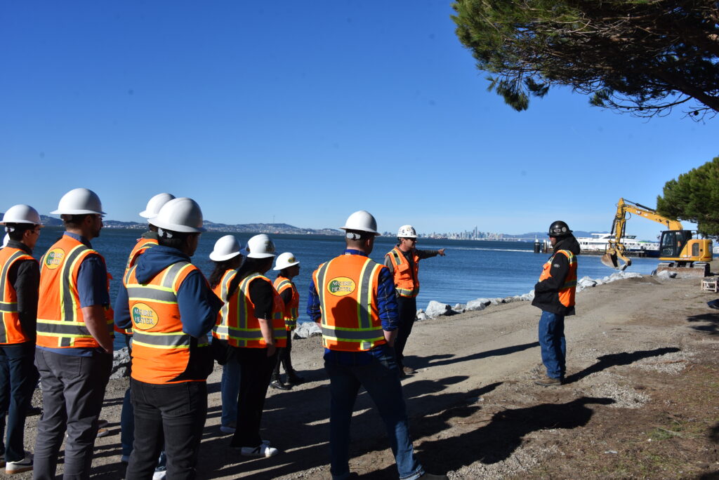 Group of employees being guided by workers on the job site