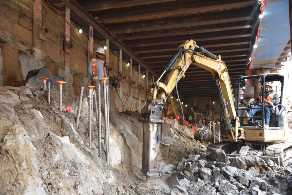 Construction worker and heavy construction equipment on a job site